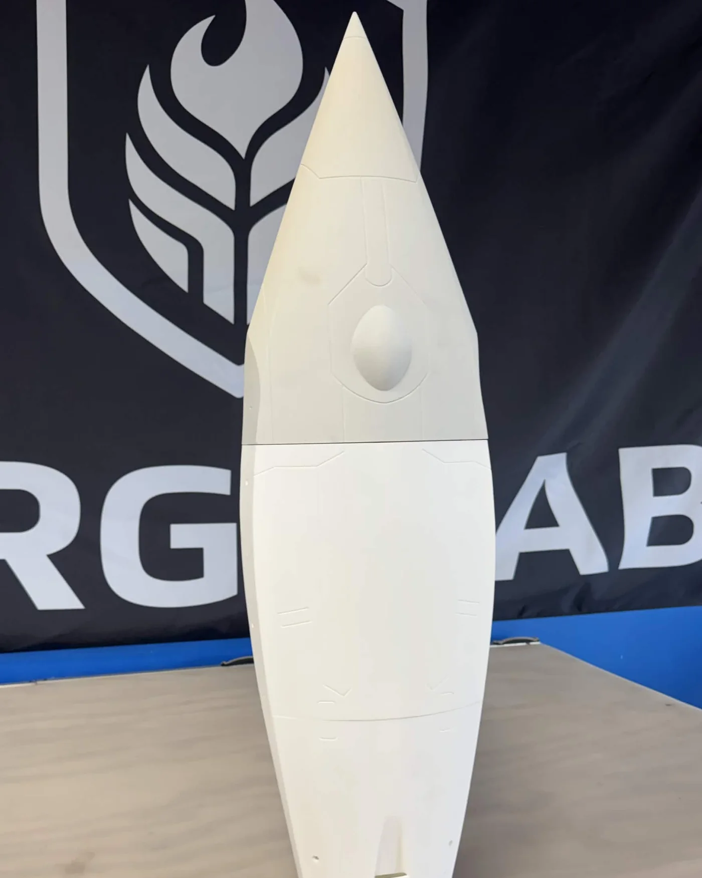 Assembled white FARSIDE rocket hardware standing on a workbench
