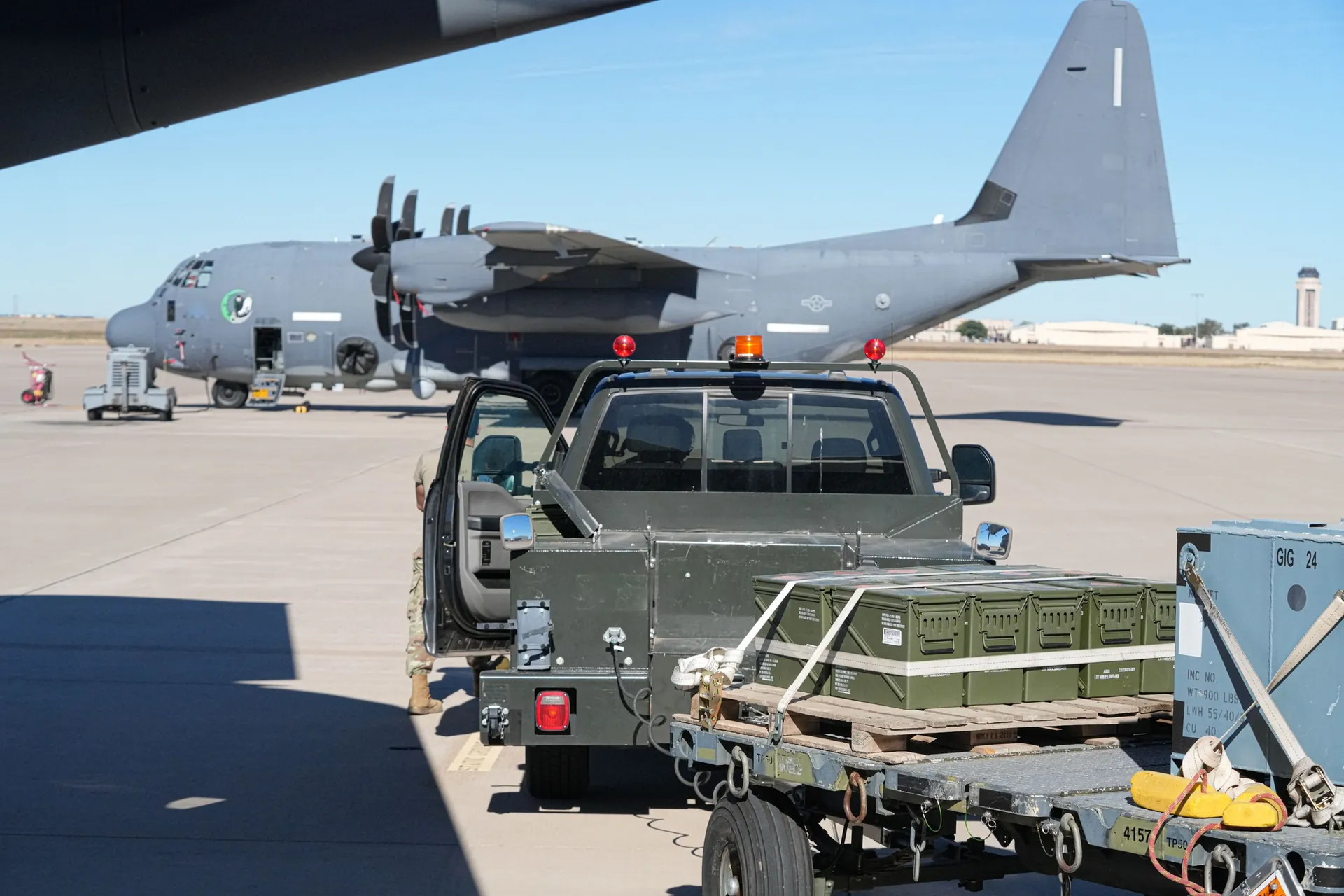 Crew loading 105mm ammunition aboard an AC-130J, representative host system